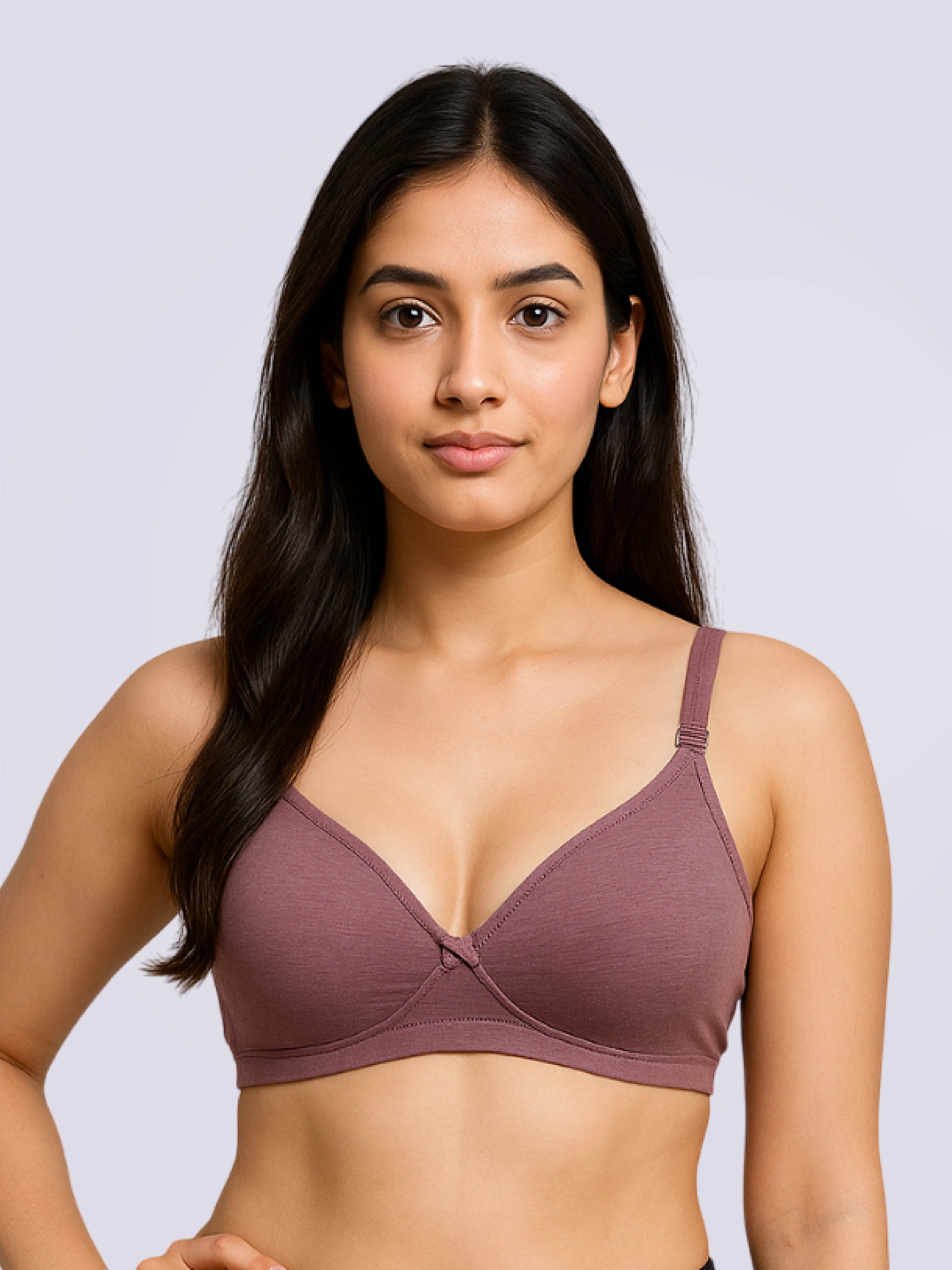 Woman wearing a purple bra against a light gray background